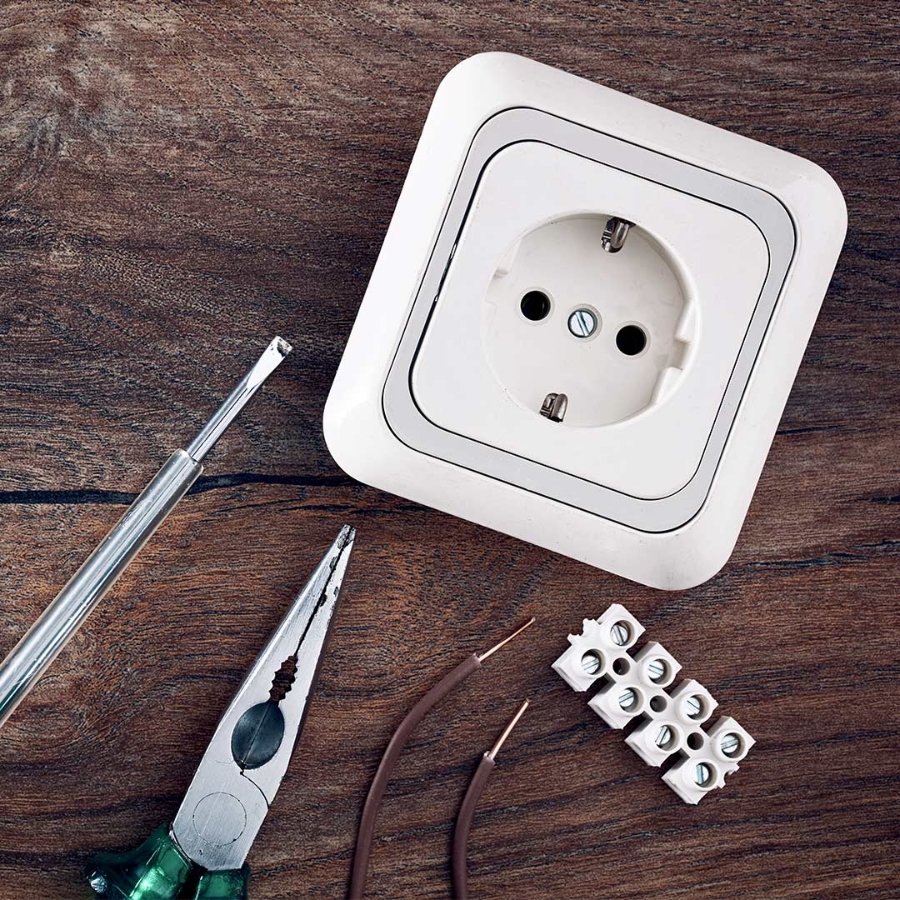 Set of electrical work tools on wooden table background